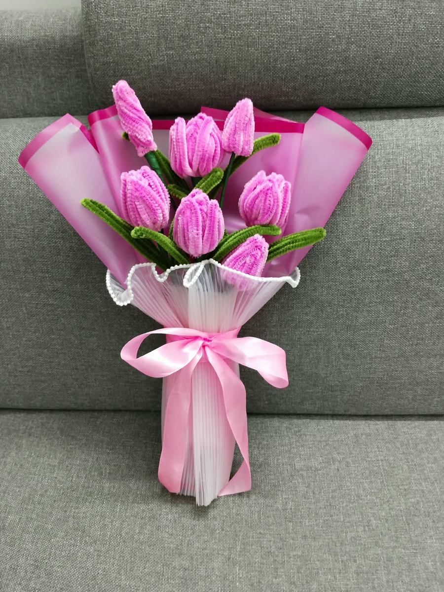 Handmade pink tulip bouquet in pink wrap with a satin bow