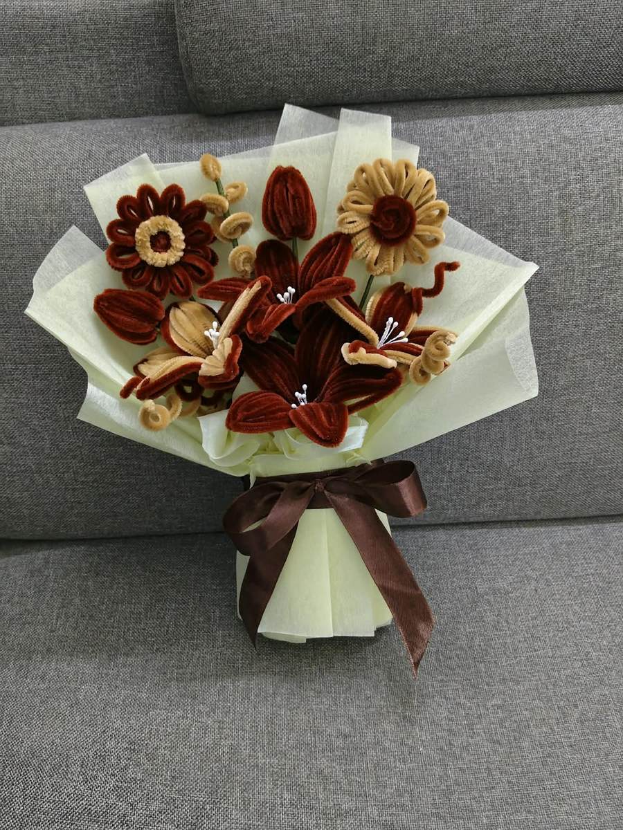 Handmade rust and cream bouquet of lilies, tulips and daisies in ivory wrap