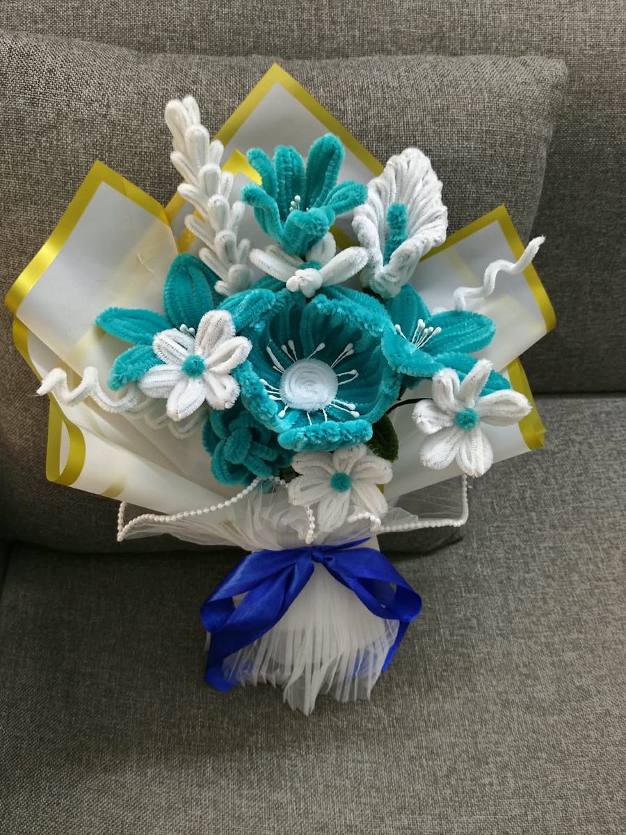 Handmade teal and white bouquet with pearl detailing and a blue ribbon